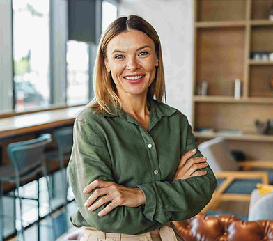 A woman standing in a calm office setting.